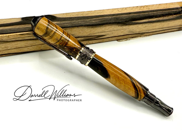 Hand-turned black and white ebony wood pen by STICS and STONES, showcasing smooth craftsmanship and elegant design.