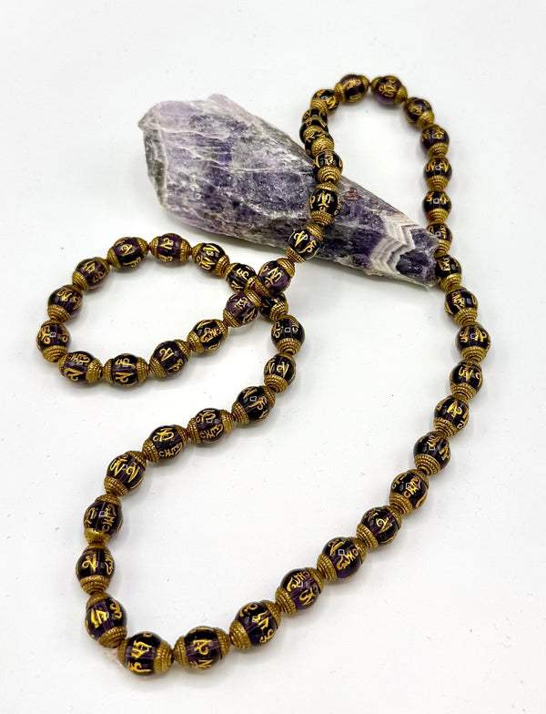 Amethyst necklace with carved pendant from STICS and STONES, showcasing a polished purple gemstone on a delicate chain.