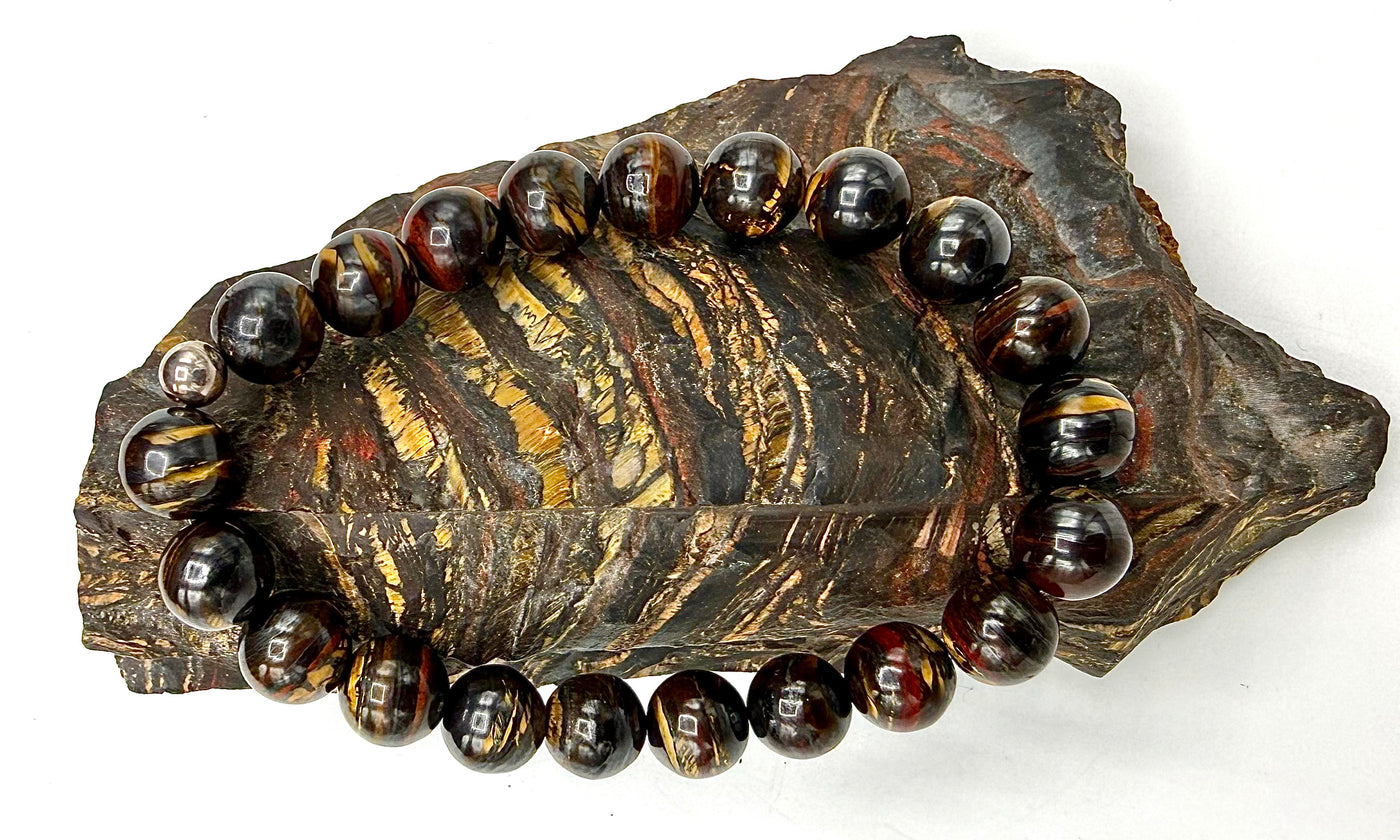 Tiger Iron bracelet by STICS and STONES featuring polished tiger iron stones on a elastic band.