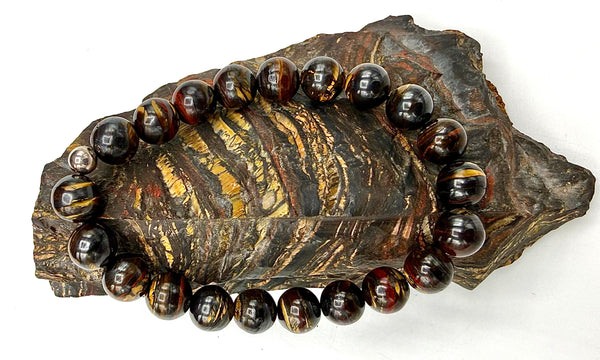 Tiger Iron bracelet by STICS and STONES featuring polished tiger iron stones on a elastic band.