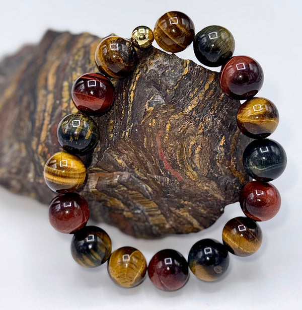 Multicolored Tiger Eye bracelet by STICS and STONES featuring polished round stones on an elastic band.