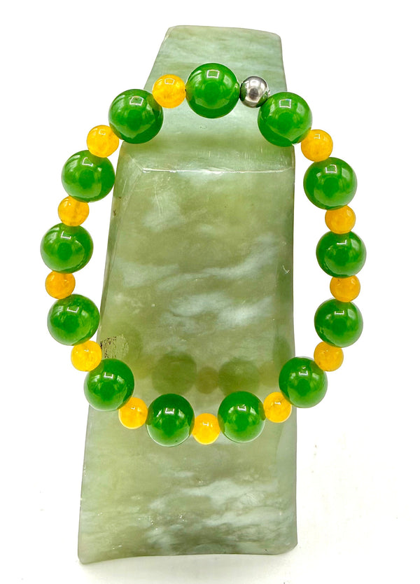 Green aventurine and yellow quartz bracelet with beads, handcrafted by STICS and STONES, on a neutral background.