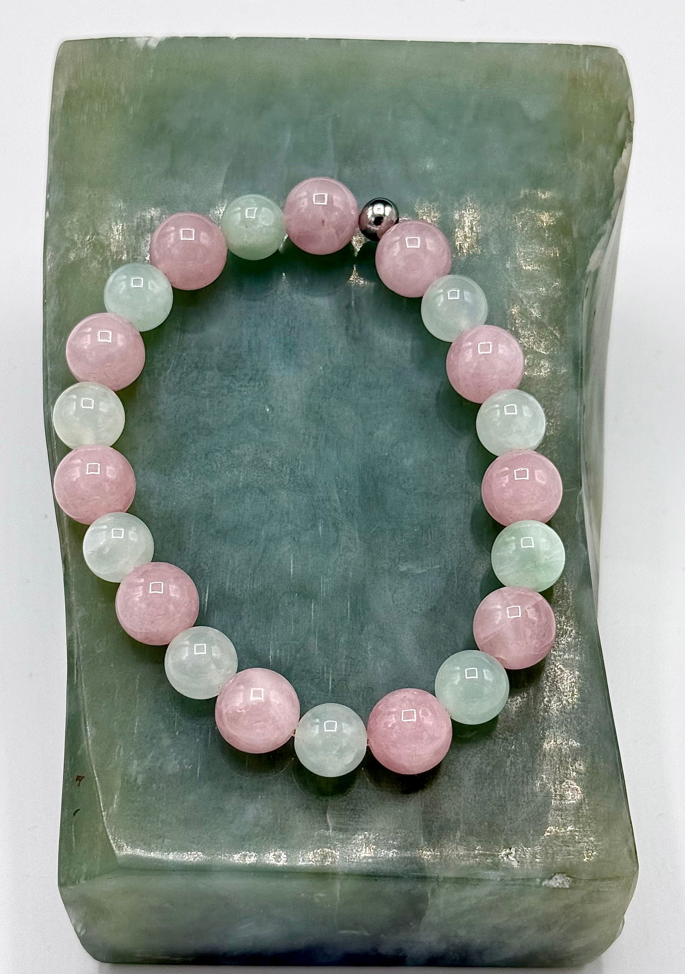 Rose quartz and prehnite bracelet featuring polished beads, designed by STICS and STONES, displayed on a neutral background.