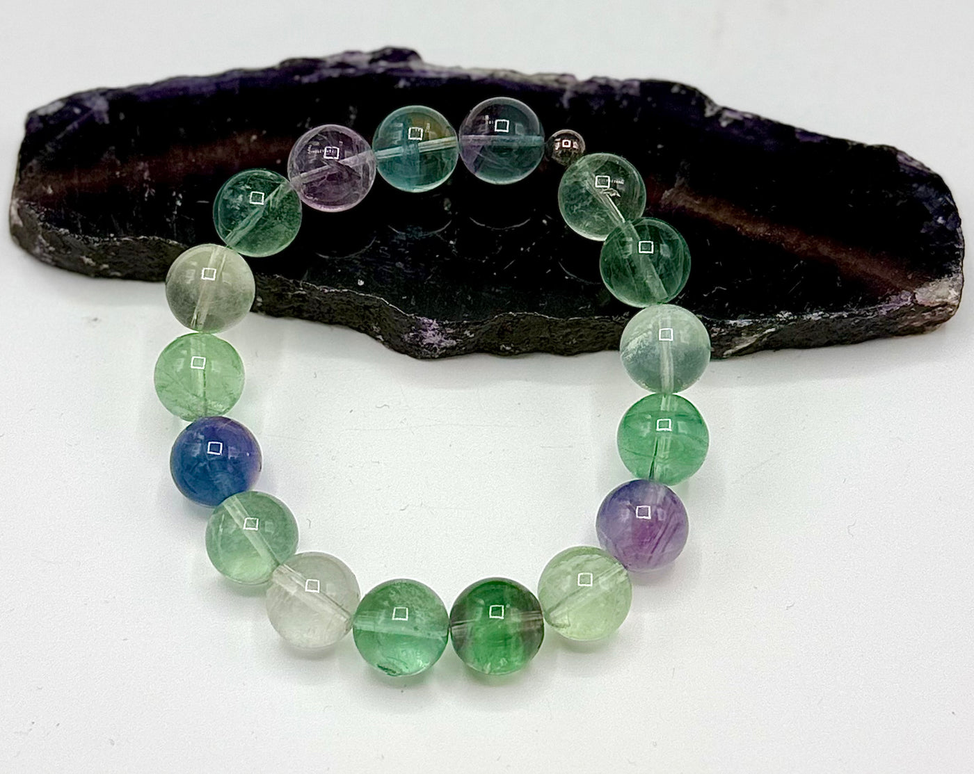 Colorful fluorite bracelet featuring smooth, polished stones on an elastic band from STICS and STONES.