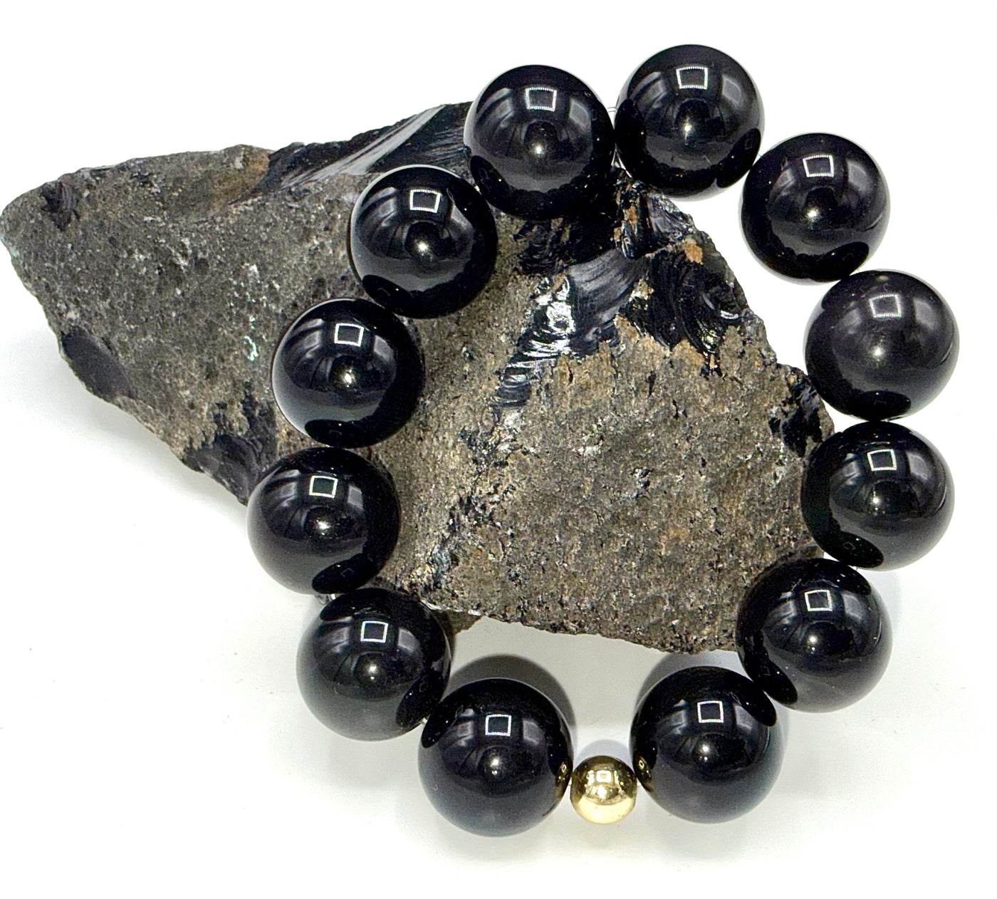 Rainbow Obsidian Bracelet featuring vibrant rainbow-colored stones on a stretch bracelet from STICS and STONES.