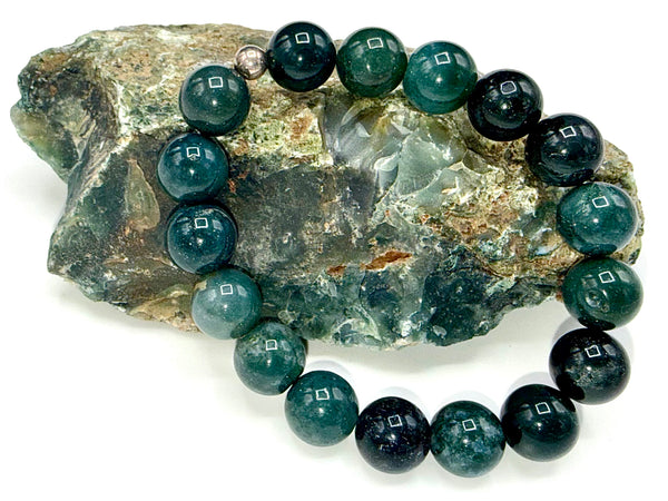 Green Agate bracelet by STICS and STONES featuring polished green agate beads on an elastic band.