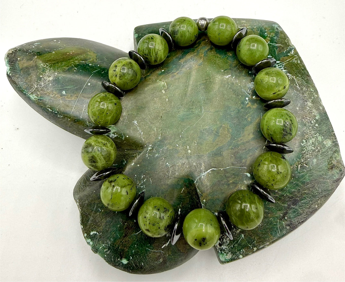 Green Zoisite stone bracelet featuring polished beads, crafted by STICS and STONES, shown on a neutral background.