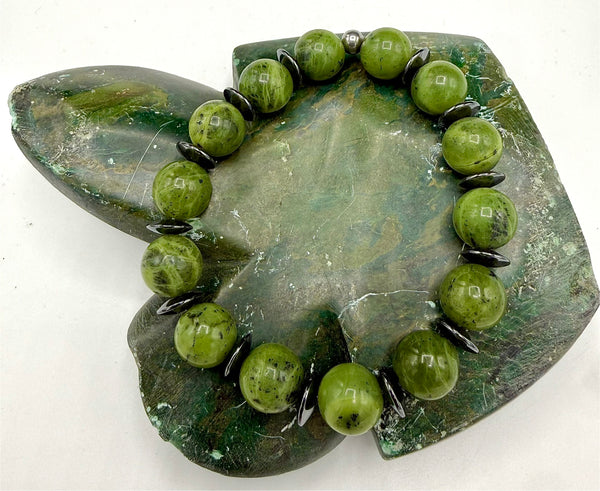 Green Zoisite stone bracelet featuring polished beads, crafted by STICS and STONES, shown on a neutral background.