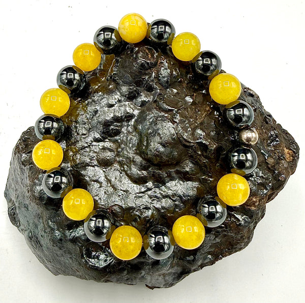 Yellow jade and hematite bracelet by STICS and STONES featuring smooth beads and a stylish, natural gemstone design.