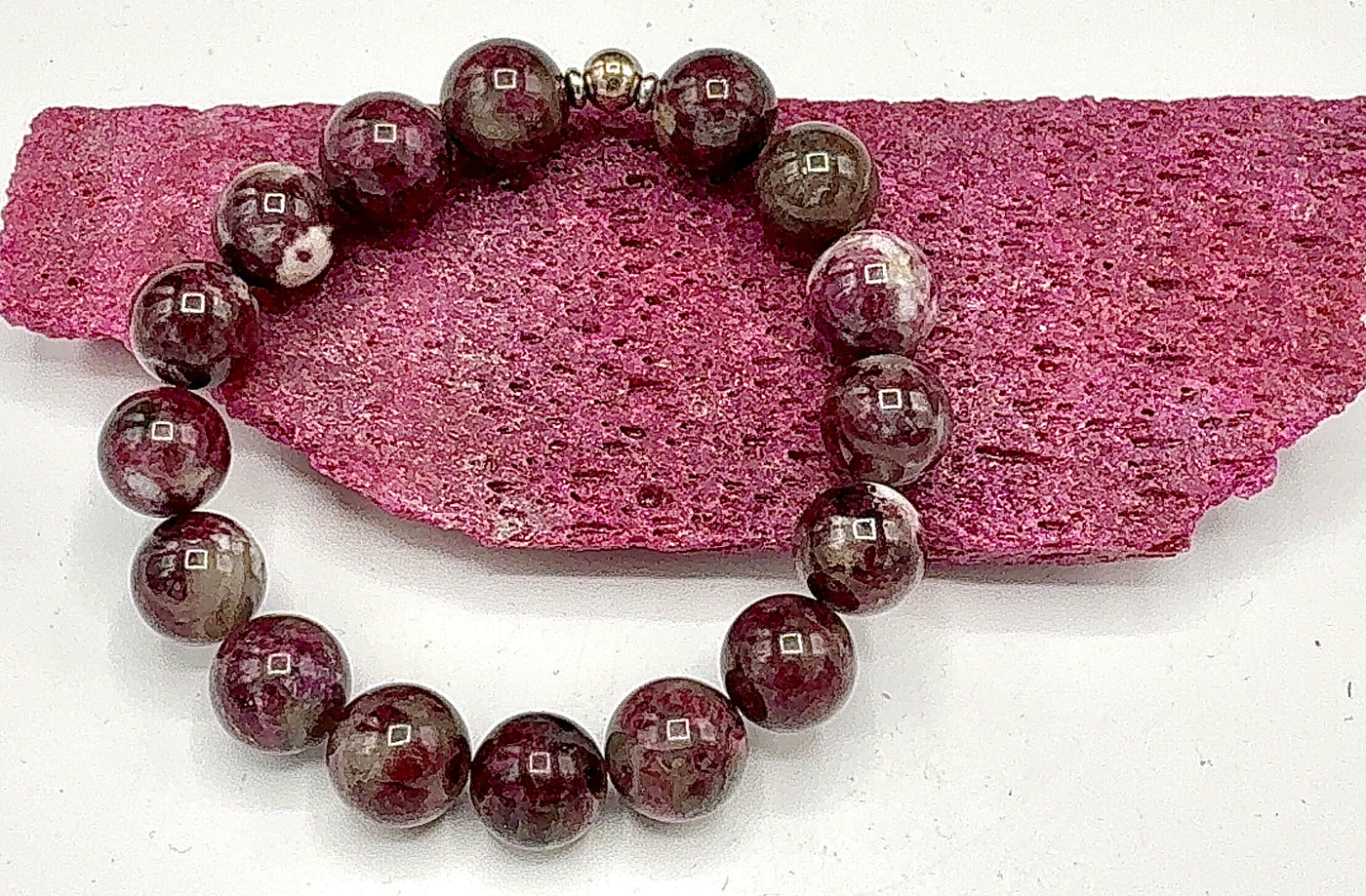 Rubellite and white gemstone bracelet by STICS and STONES featuring vibrant red and clear beads on a delicate string.