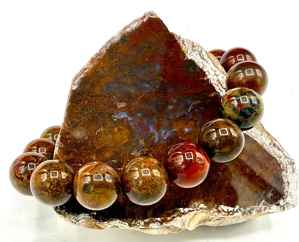 Pietersite with skull charm bracelet by STICS and STONES featuring polished pietersite beads and a detailed skull pendant.