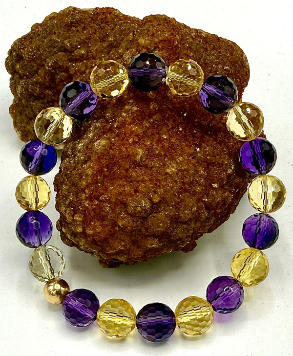 Faceted amethyst and citrine rectangle bracelet with silver-tone clasp from STICS and STONES on a white background.