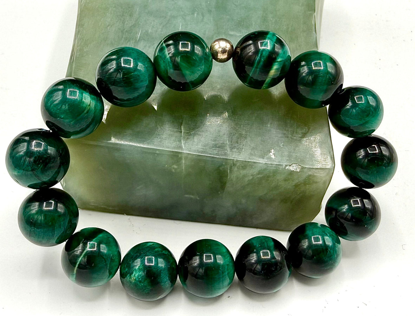 Emerald green tiger eye bracelet by STICS and STONES featuring polished tiger eye beads on a stretch cord.