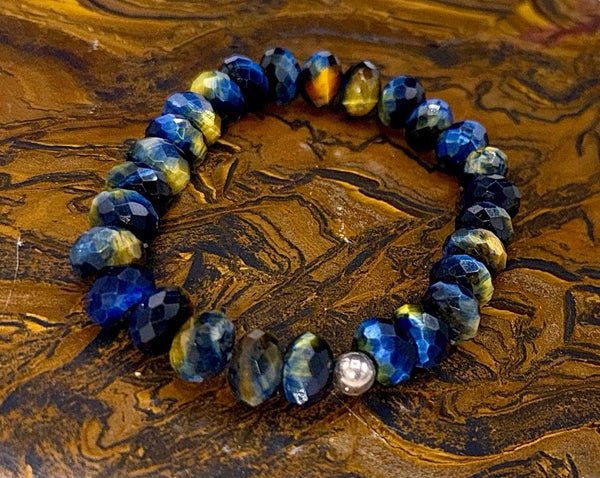 Blue and golden tiger eye bracelet featuring polished stones, crafted by STICS and STONES, displayed on a neutral background.
