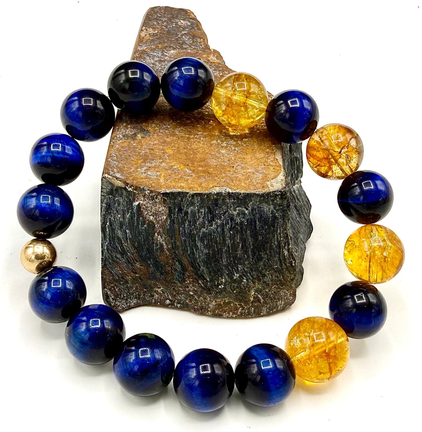 Blue tiger eye and citrine bracelet featuring polished stones, designed by STICS and STONES, displayed on a neutral background.