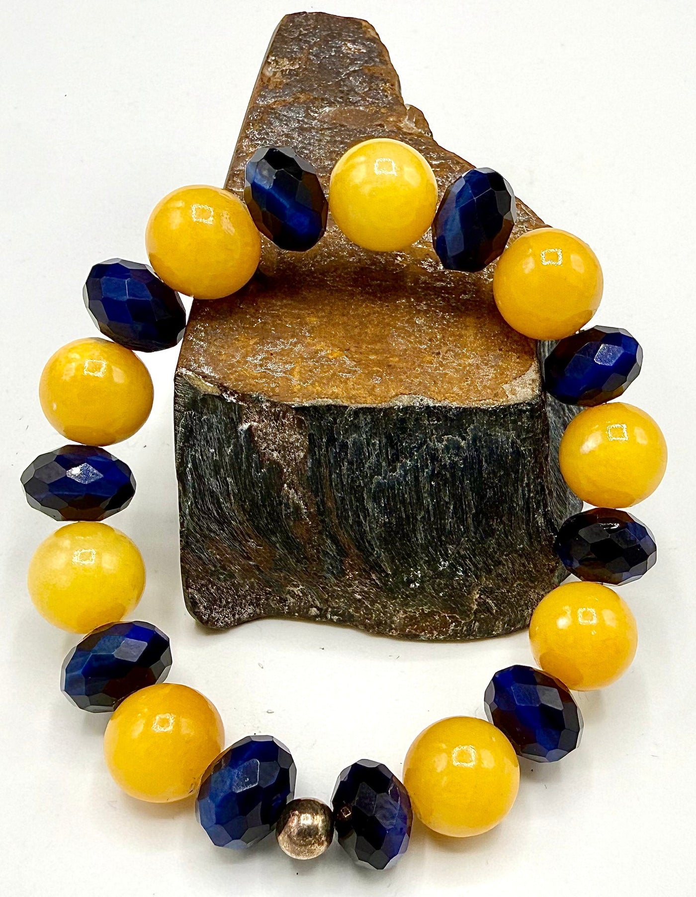 Blue tiger eye and yellow calcite bracelet featuring polished beads from STICS and STONES.