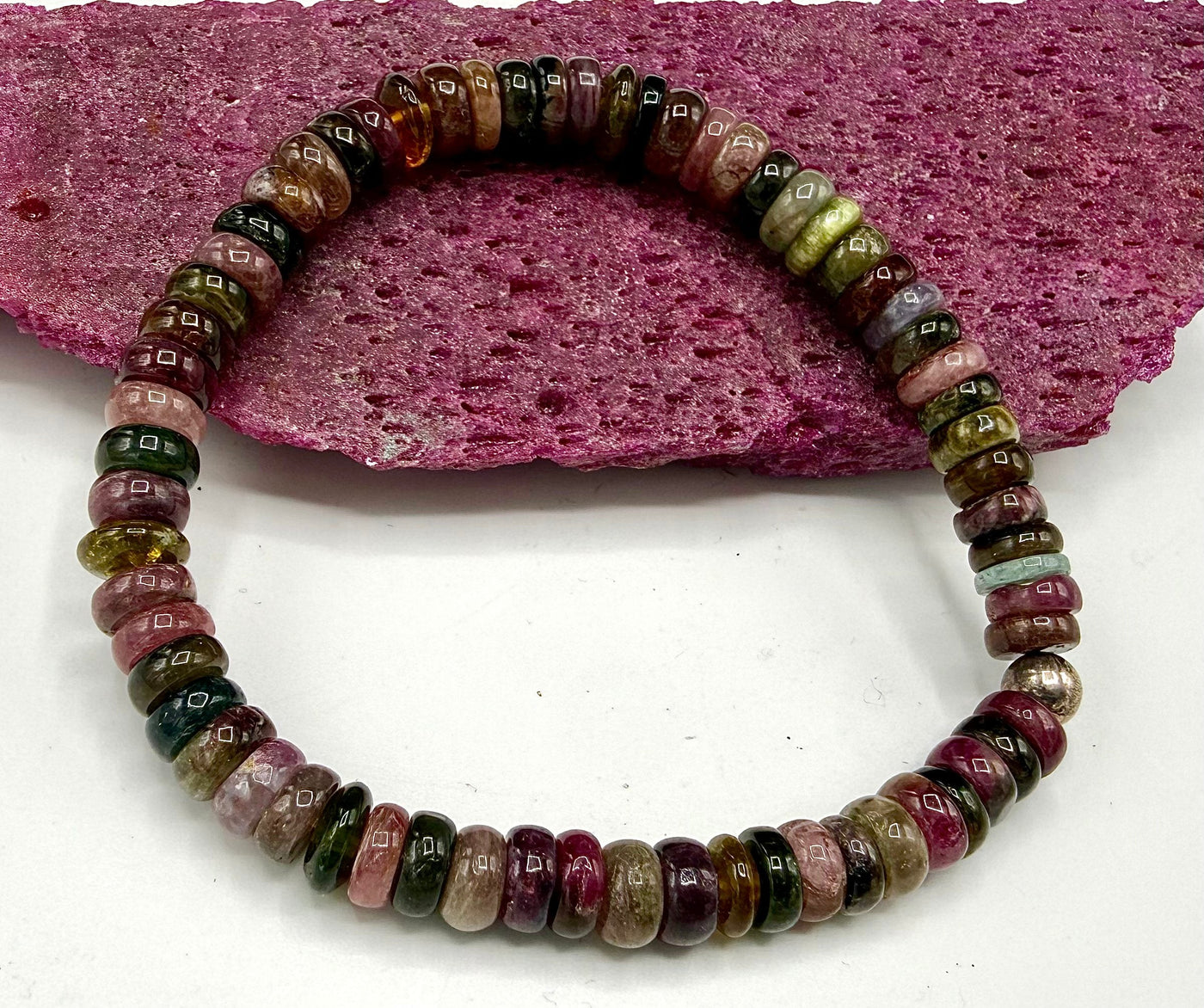 Tourmaline bracelet from STICS and STONES with multicolored gemstone beads on a delicate elastic band.