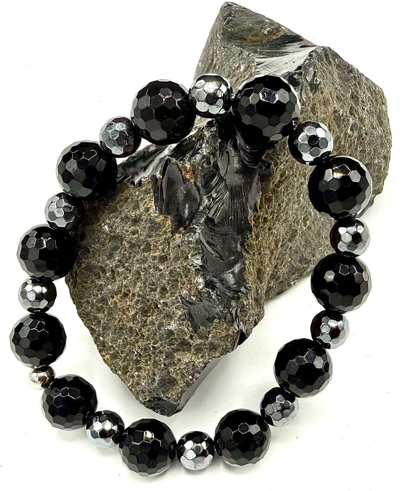 Hematite and onyx bracelet with polished black and metallic gray beads from STICS and STONES displayed on a neutral background.