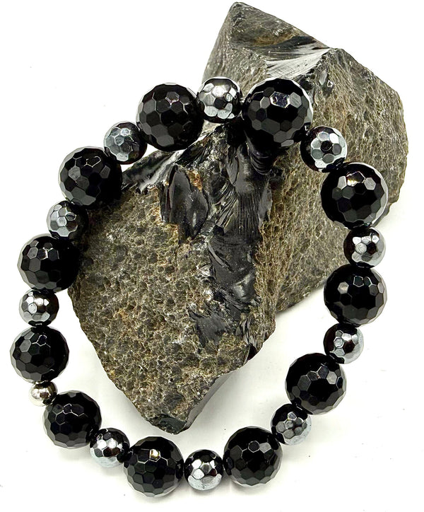 Hematite and onyx bracelet with polished black and metallic gray beads from STICS and STONES displayed on a neutral background.