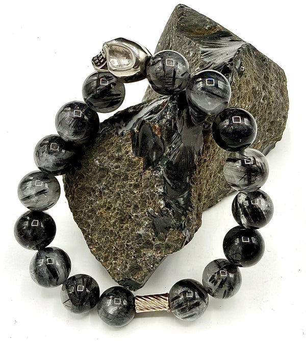 Black Tourmaline Quartz bracelet featuring polished black stones on a stretch band from STICS and STONES.