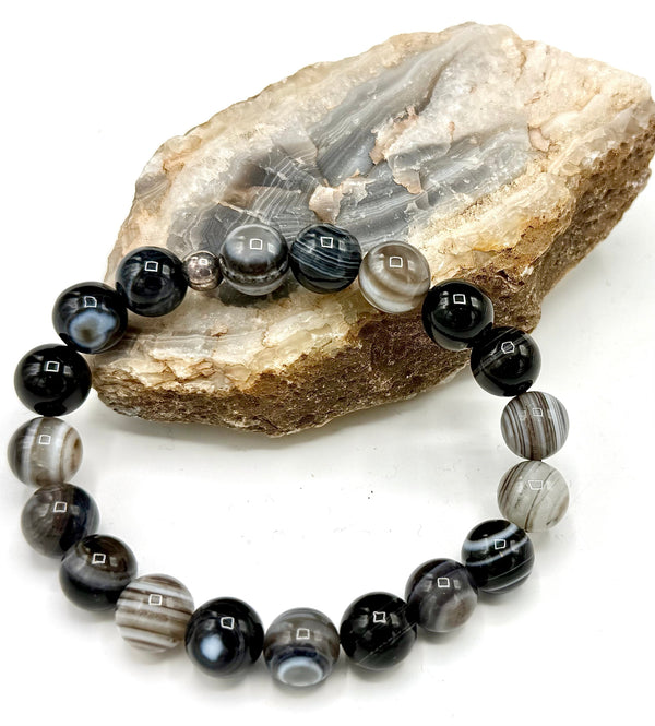 Botswana Agate bracelet by STICS and STONES featuring polished oval beads on a stretch cord, showcasing natural banding and earthy tones.