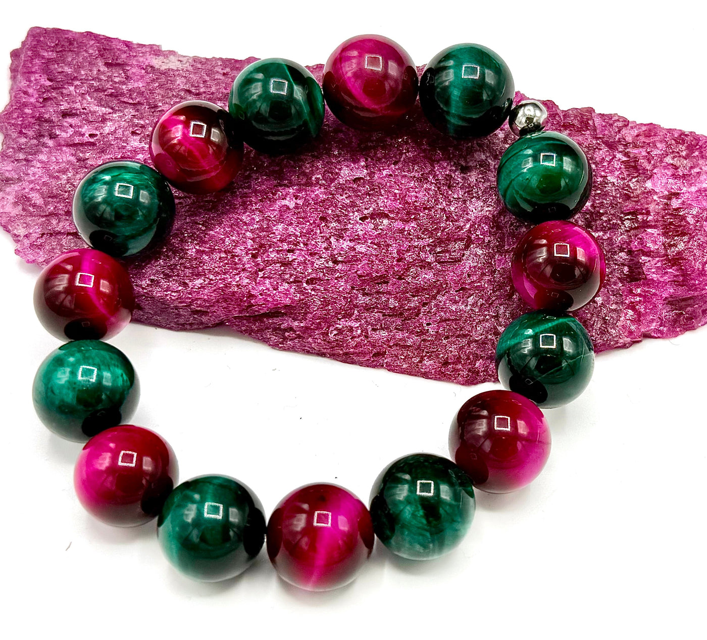 Multi-colored pink and green tiger eye bracelet by STICS and STONES, featuring dyed, polished beads on a stretch band.