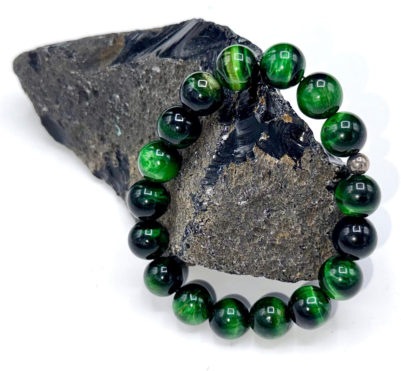 Green Tiger Eye bracelet featuring polished beads, strung together on an elastic band, showcasing natural stone patterns and vibrant color.