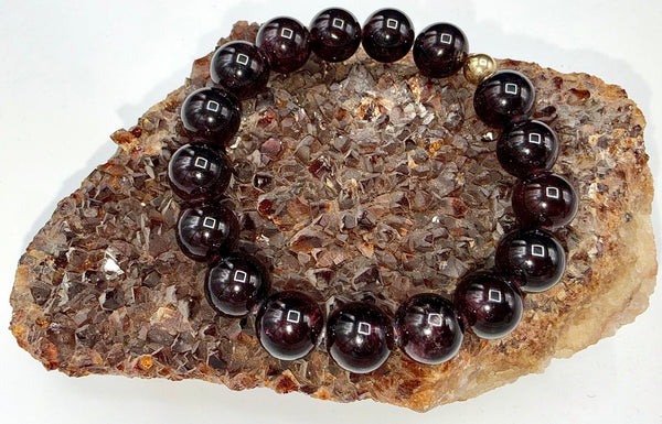 Garnet bracelet featuring polished red gemstone beads on a string, designed by STICS and STONES.