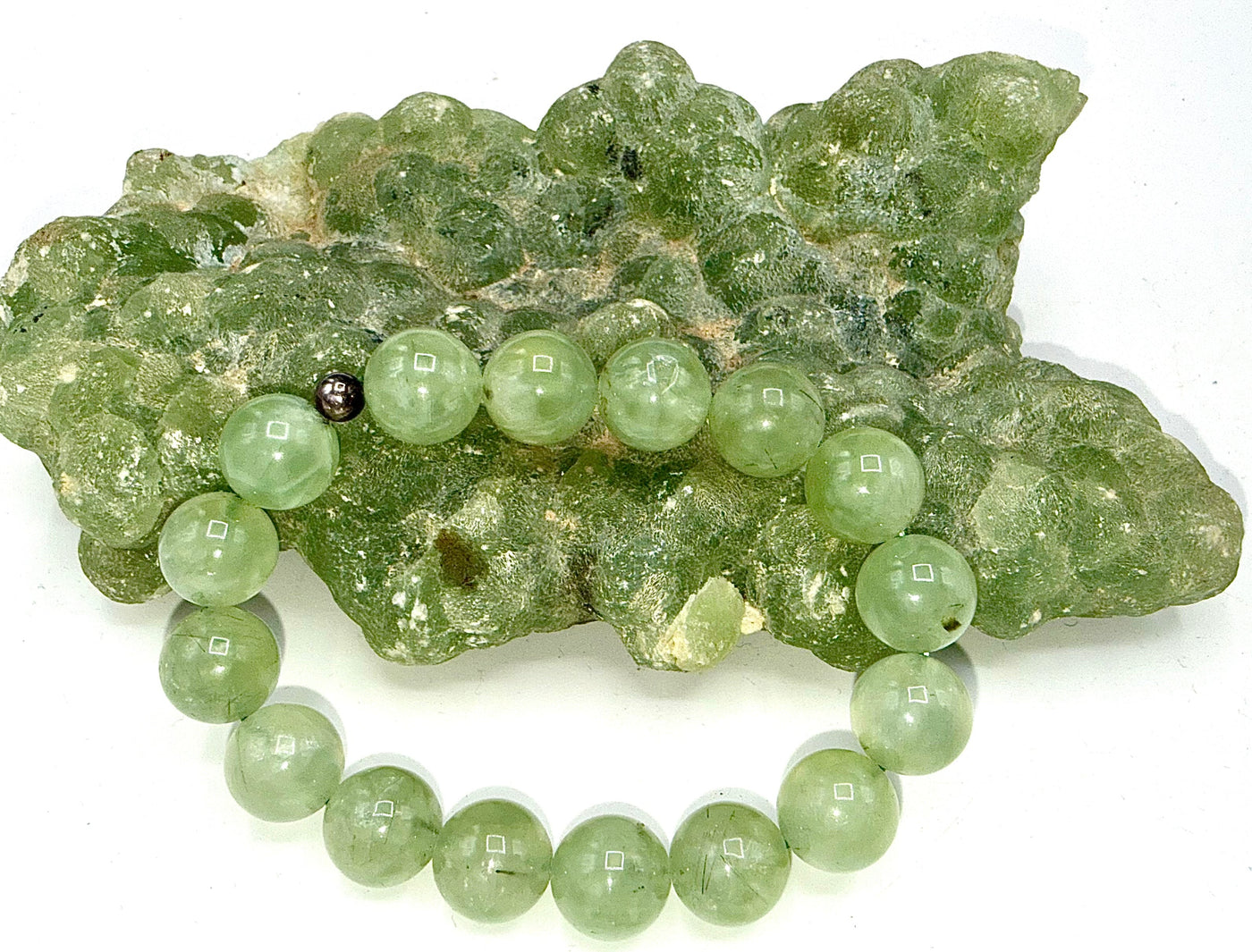 Prehnite bracelet featuring smooth green gemstone beads from STICS and STONES, displayed on a neutral background.