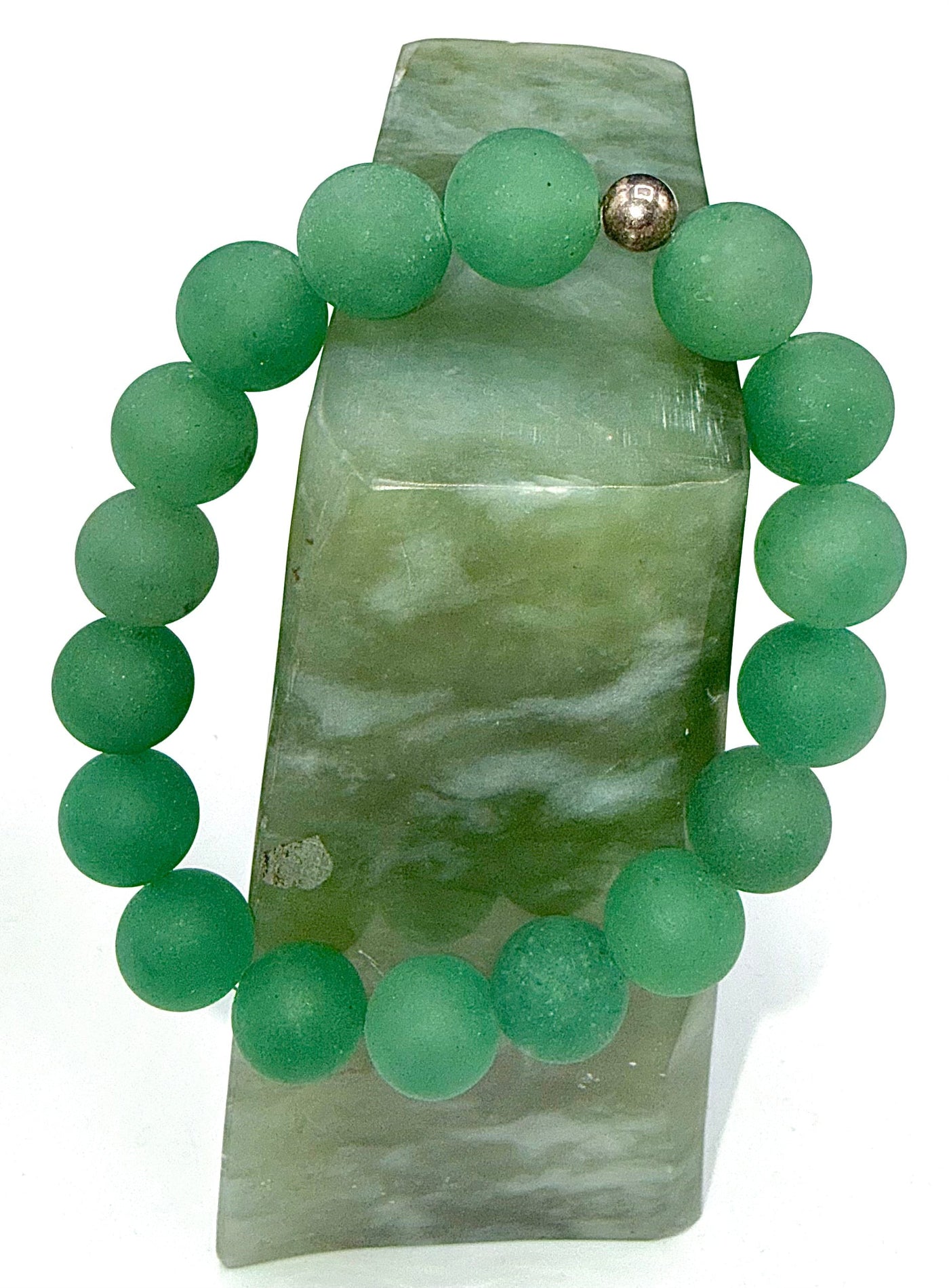 Green Aventurine bracelet with polished beads from STICS and STONES, displayed on a neutral background.