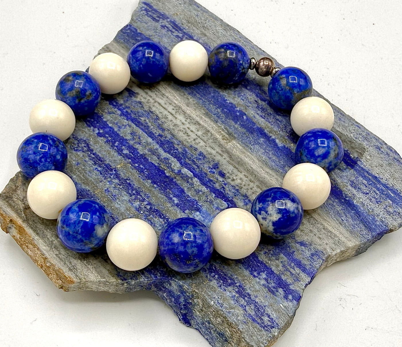 Lapis Lazuli and bone bracelet with beaded design from STICS and STONES, showing a close-up of the handcrafted jewelry.