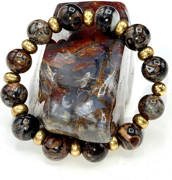 Black and brown lepidolite bracelet featuring polished stones, designed by STICS and STONES, displayed on a neutral background.