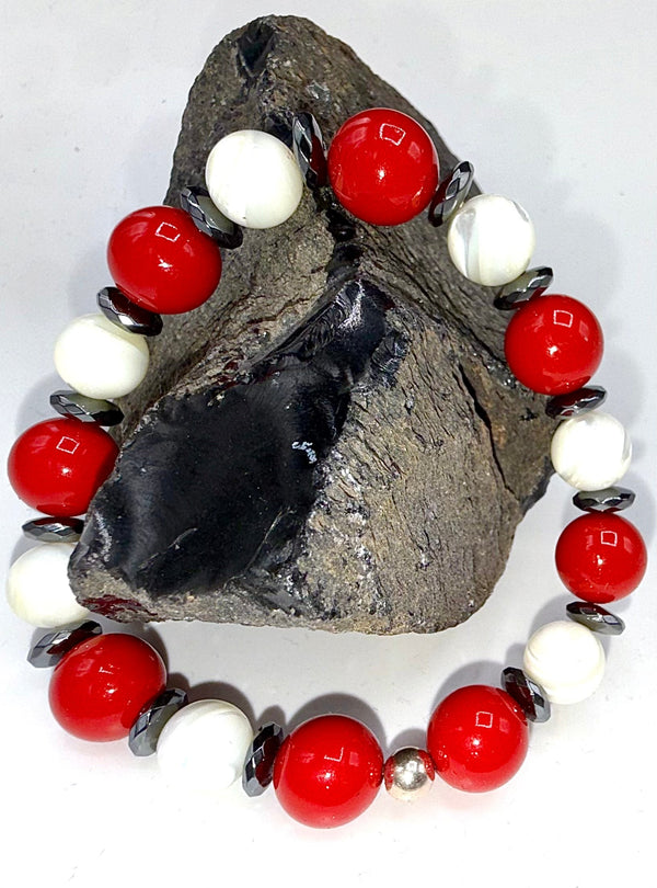 Red and pearl bracelet by STICS and STONES featuring red beads and elegant pearl accents on a delicate bracelet.