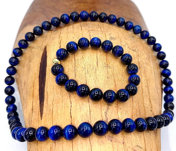 Blue tiger eye jewelry set featuring a necklace and bracelet with dark and light stones, crafted by STICS and STONES.