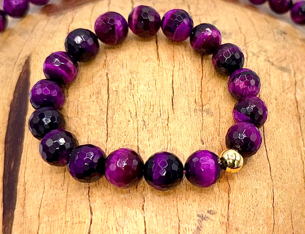 Purple Tiger Eye bracelet featuring polished beads from STICS and STONES, showcasing vibrant purple and golden hues.