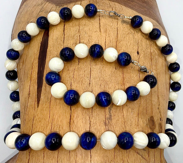 Blue Tiger Eye and pearl jewelry set featuring a necklace and bracelet by STICS and STONES, displayed on a neutral background.
