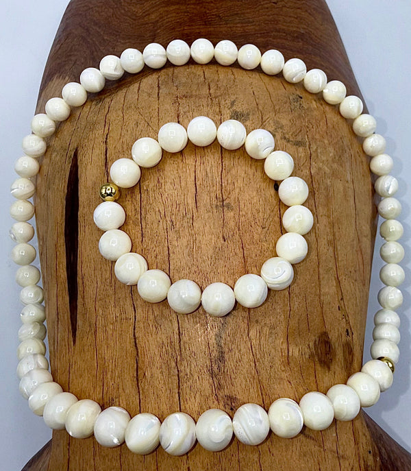 Elegant pearl jewelry set featuring a necklace and bracelet by STICS and STONES, showcasing lustrous white pearls and delicate design.