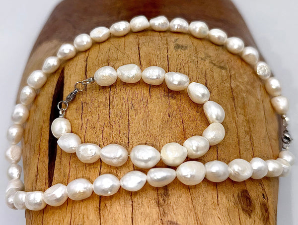 Smaller pearl necklace and bracelet jewelry set by STICS and STONES featuring elegant white pearls on a delicate chain and bracelet.