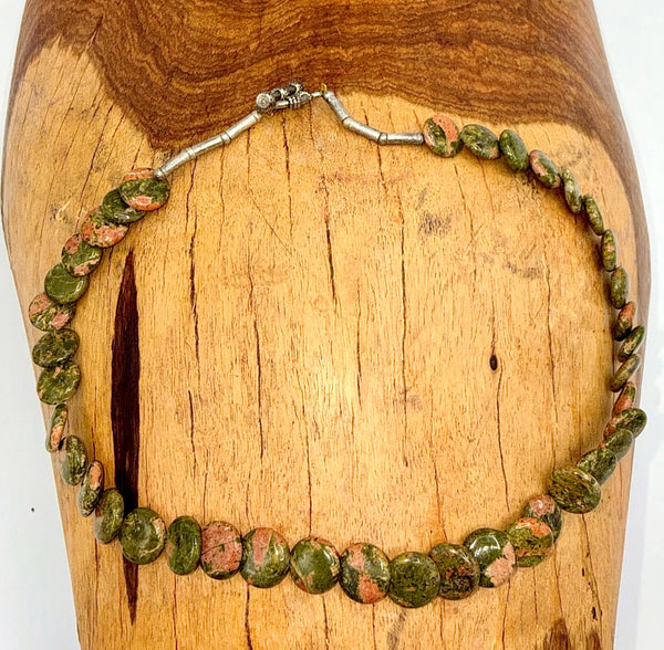 Unakite flat necklace with polished green and orange gemstone beads, showcasing natural stone variations and a sleek design.