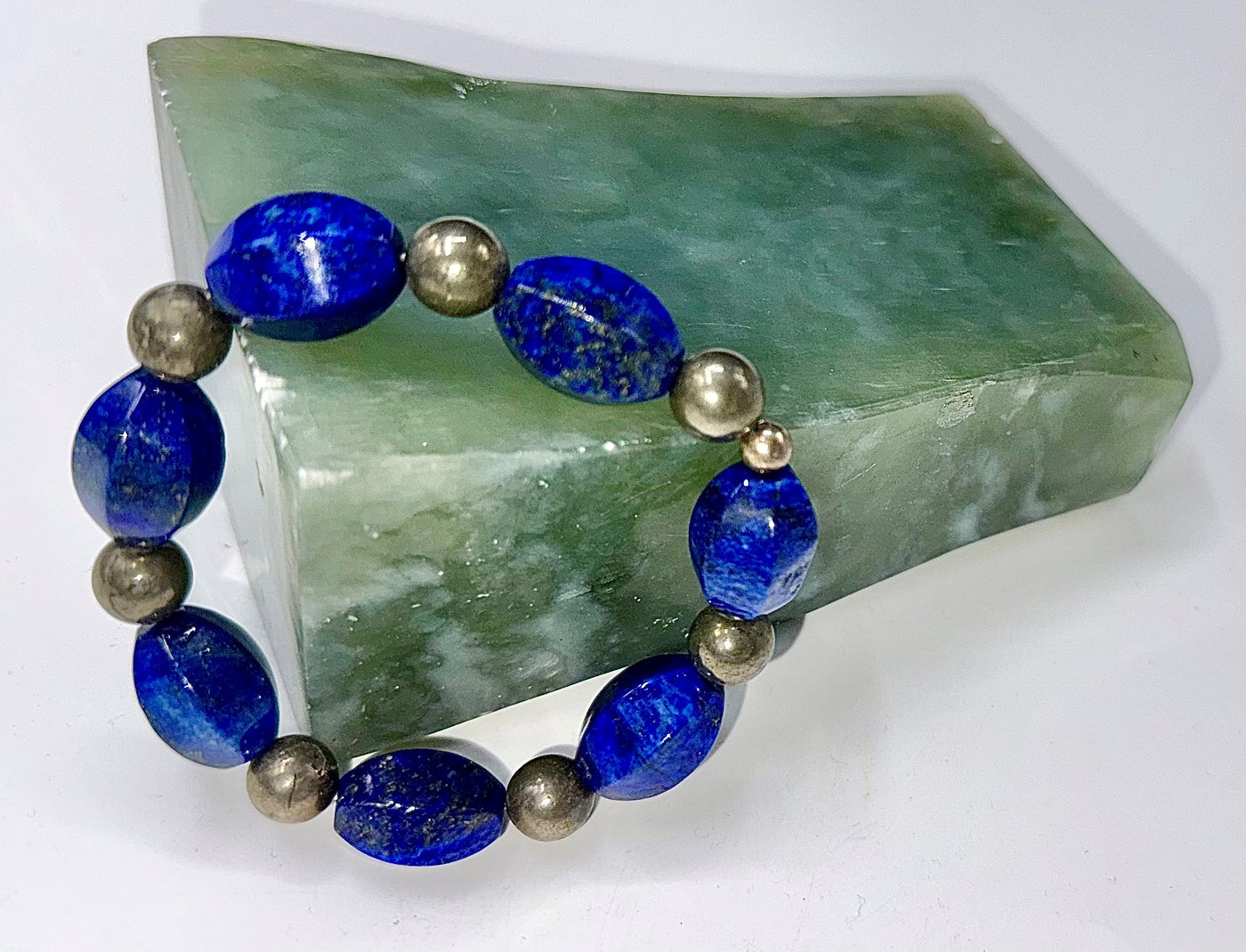 Lapis Lazuli and pyrite beaded bracelet from STICS and STONES featuring vibrant blue stones and metallic gold accents.