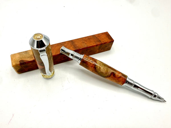 Hand-turned Amboyna burl pen by STICS and STONES with a polished wood finish and metal accents.