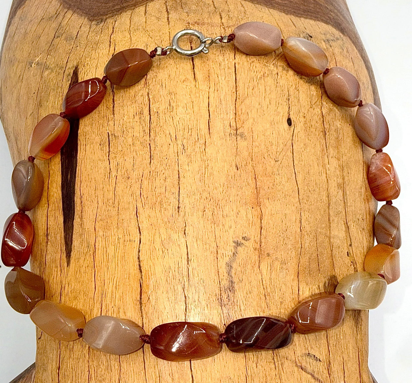 Carnelian agate necklace featuring vibrant orange-red stones on a delicate chain, crafted by STICS and STONES.
