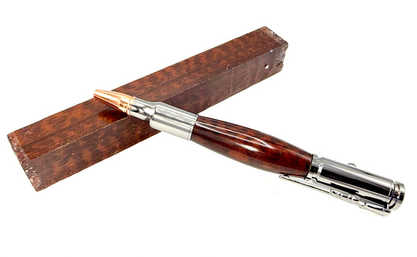 Hand-turned Snakewood Bullet Pen by STICS and STONES with polished finish and metal accents, showcasing a sleek, elegant writing instrument.