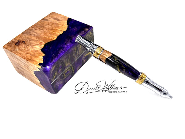 Hand-turned purple and gold acrylic and hardwood pen by STICS and STONES, showcasing a detailed wooden and acrylic pen design.