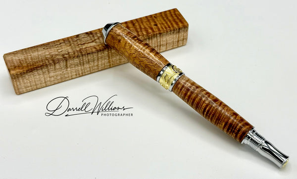 Hand-turned Hawaiian curly Koa pen by STICS and STONES, featuring a smooth wooden finish and elegant craftsmanship.