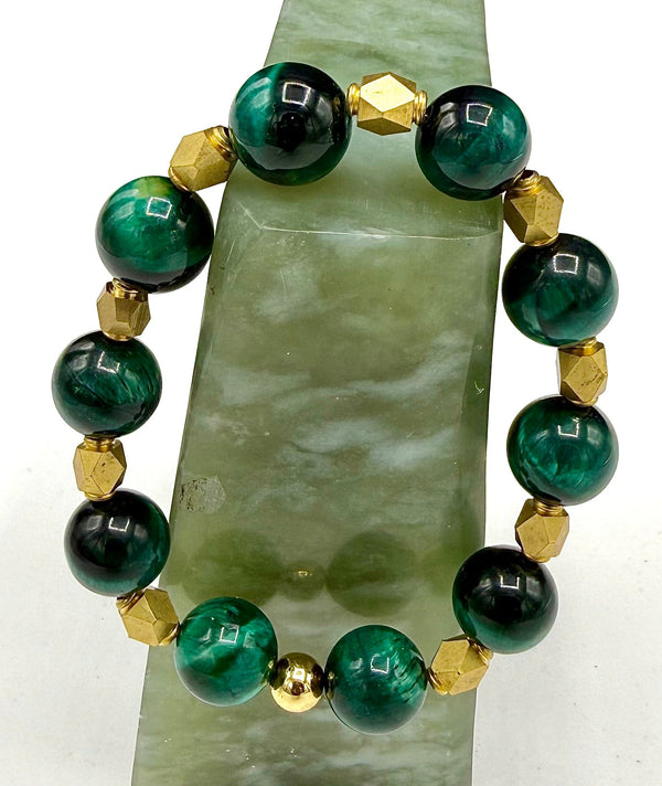 Emerald green Tiger Eye bracelet with brass spacers from STICS and STONES, showcasing polished gemstone beads and metallic accents.