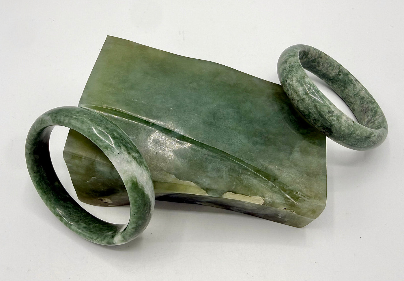 Elegant jade bangle by STICS and STONES featuring a smooth, polished finish and vibrant green color.