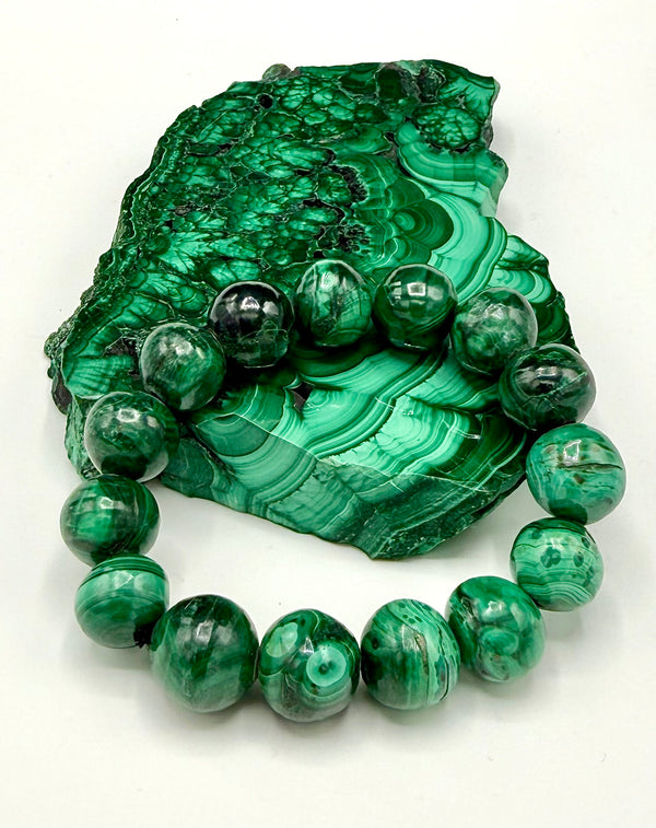Stacked green malachite bracelet by STICS and STONES featuring polished beads with a smooth, shiny surface.