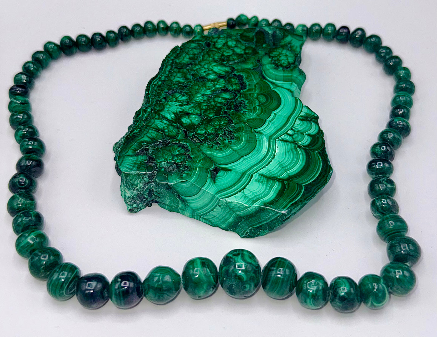 Malachite necklace from STICS and STONES featuring polished green gemstone beads and a silver clasp.