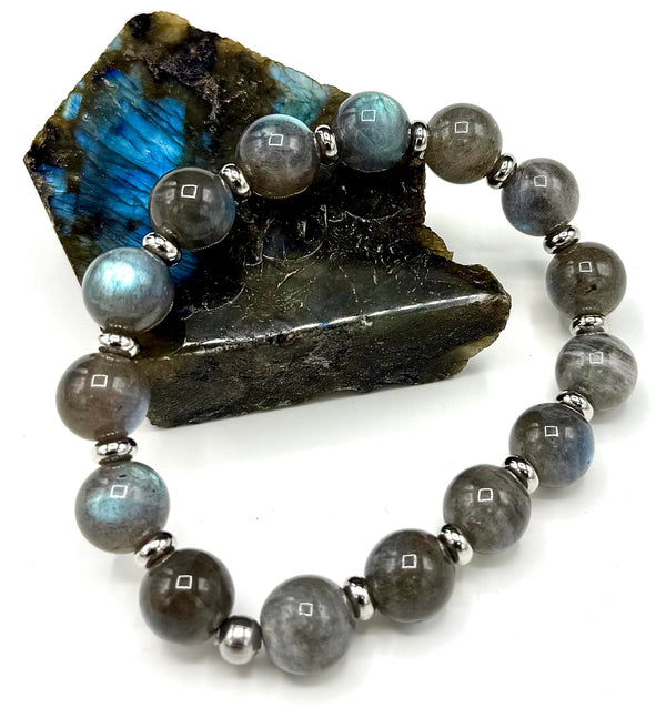 Labradorite bracelet featuring polished, iridescent stones on a delicate string, showcasing vibrant blue and green flashes.